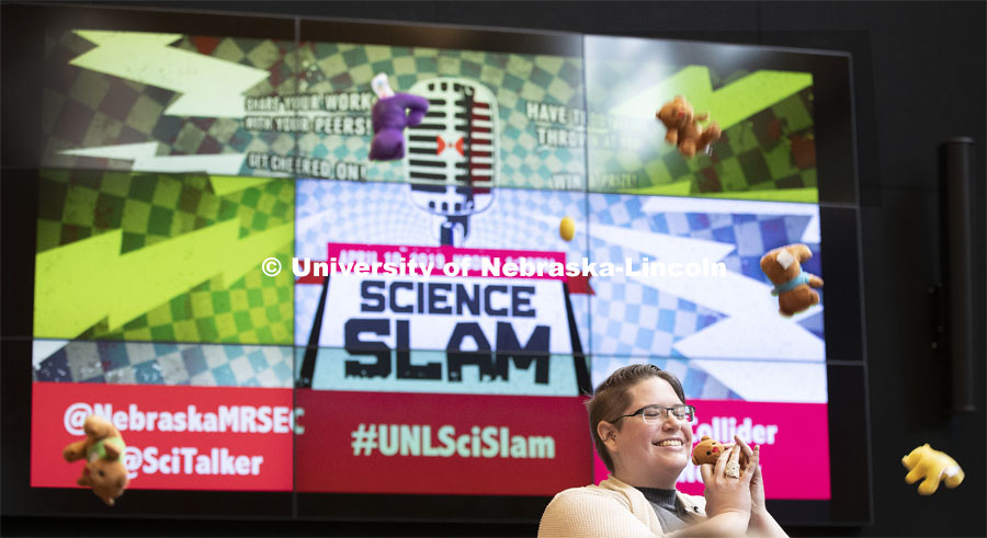Recent graduate Nicole Benker holds a teddy bear thrown onto the stage in appreciation of her performance. Nebraska’s fourth annual Science Slam held at Wick Alumni Center. April 9 2019. Photo by Craig Chandler / University Communication.