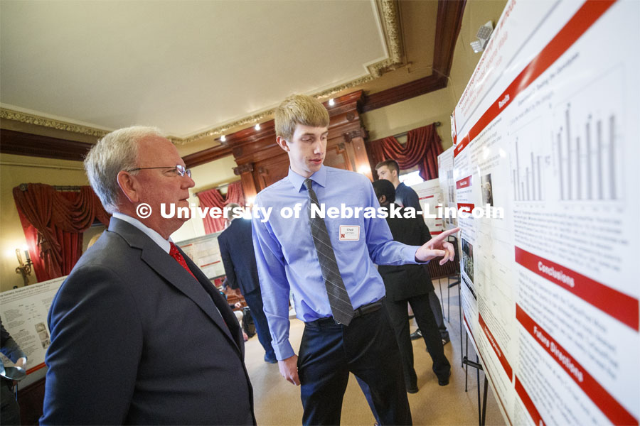 Chad Lammers of Hartington, NE, discusses his research "Elucidating the Effects of Domestication and Modern Breeding on Root Plasticity for Drought Adaptation in Wheat" with Sen. Tim Gragert of District 40. State Senators Research Fair at the Ferguson House. April 16, 2019. Photo by Craig Chandler / University Communication.