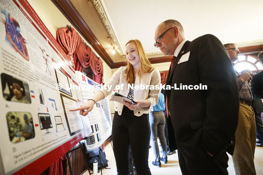 Erica Dolph of Lincoln explains her research "Mobile Platform for Viewing and Transmitting Patient Data- A Transcranial Doppler Pilot Study" to Sen. Tom Brandt of District 32. State Senators Research Fair at the Ferguson House. April 16, 2019. Photo by Craig Chandler / University Communication.