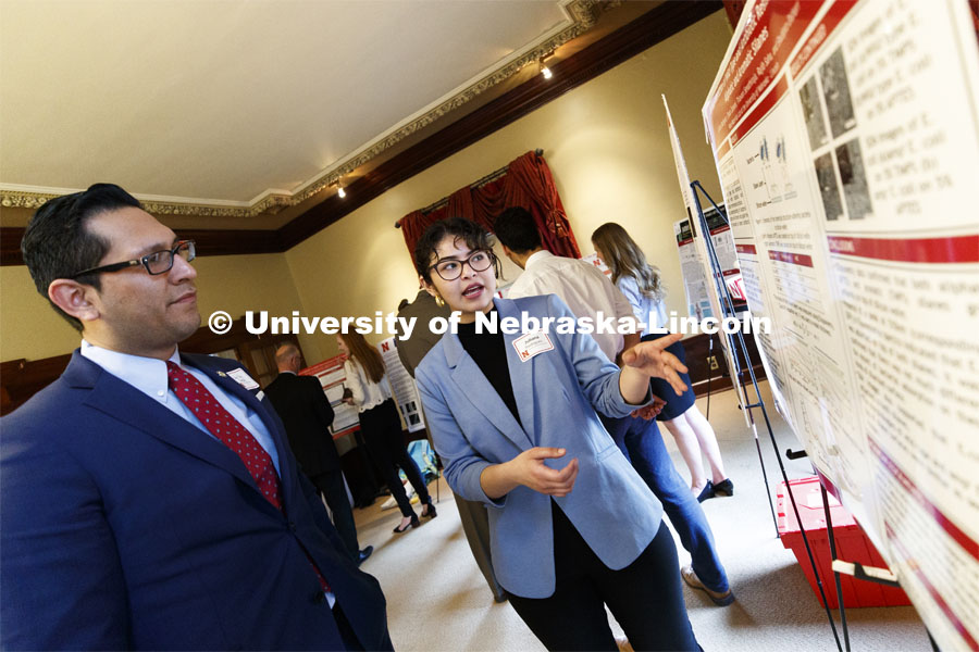 Juliana Rodriguez of Omaha explains her research "Surface Interaction of Antibiotic Resistant Bacteria: An Effective Step towards Robust Biosensor Development" to Sen. Tony Vargas of District 7. State Senators Research Fair at the Ferguson House. April 16, 2019. Photo by Craig Chandler / University Communication.