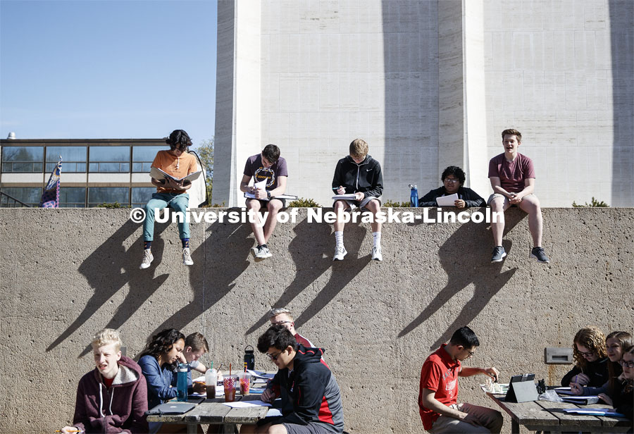 Sitting in the Sheldon sculpture garden, students in Music Theory 166 enjoy the weather during the last class period of the semester that, for some, probably seems as long as the shadows on the wall. City Campus.  April 26, 2019. Photo by Craig Chandler / University Communication.