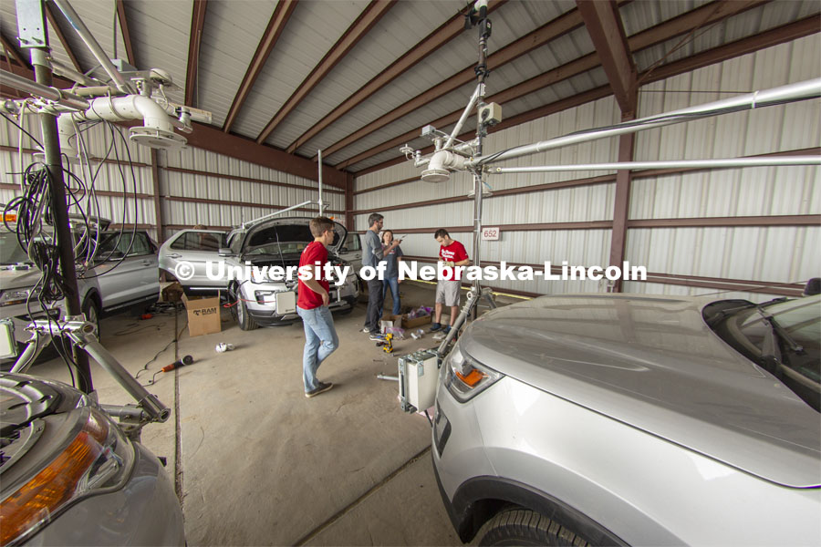 Students meet with Adam Houston (center) as they prep vehicles prior to the start of the TORUS project. TORUS Storm Chasers. April 26, 2019. Photo by Troy Fedderson / University Communication
