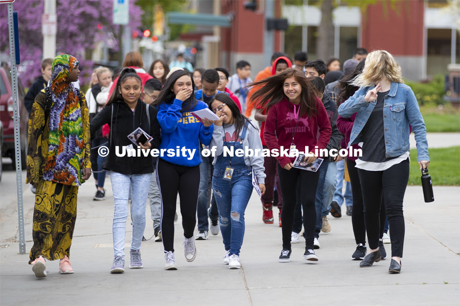 Morgan Mattly leads a group of Lexington, NE, middle schools students on a tour of campus Wednesday morning. Academic Services and Enrollment Management is working to connect with middle school students and get them thinking about college earlier. May 1, 2019. Photo by Craig Chandler / University Communication.