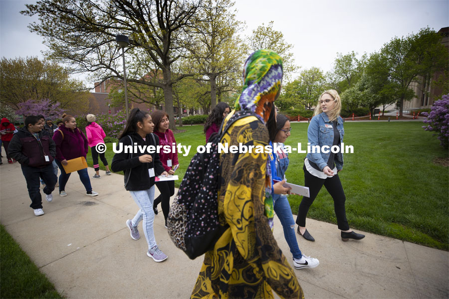 Morgan Mattly leads a group of Lexington, NE, middle schools students on a tour of campus Wednesday morning. Academic Services and Enrollment Management is working to connect with middle school students and get them thinking about college earlier. May 1, 2019. Photo by Craig Chandler / University Communication.