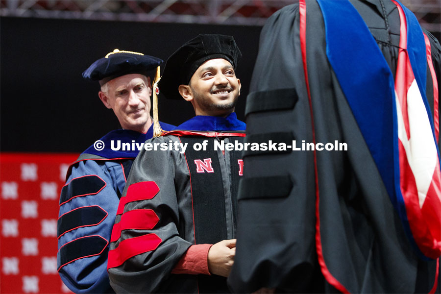 Aditya Gupta receives his doctoral hood. His dissertation: Meaningful Consumption: A Eudaimonic Perspective on the Consumer Pursuit of Happiness and Well-Being. Advised by Professor James W. Gentry. 2019 Spring Graduate Commencement in Pinnacle Bank Arena. May 3, 2019. Photo by Craig Chandler / University Communication