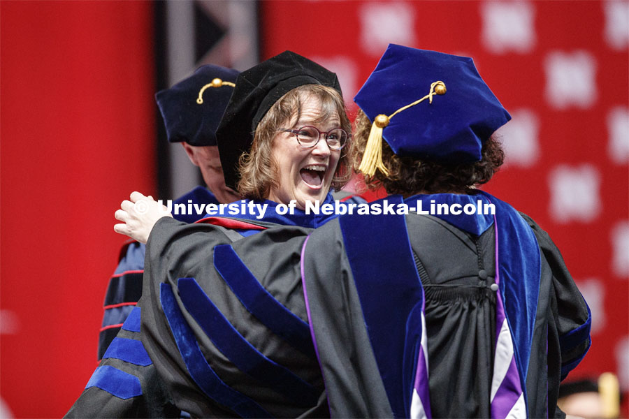 Carin Appleget reacts after her advisor Stephanie Wessels hooded her.  2019 Spring Graduate Commencement in Pinnacle Bank Arena. May 3, 2019. Photo by Craig Chandler / University Communication
