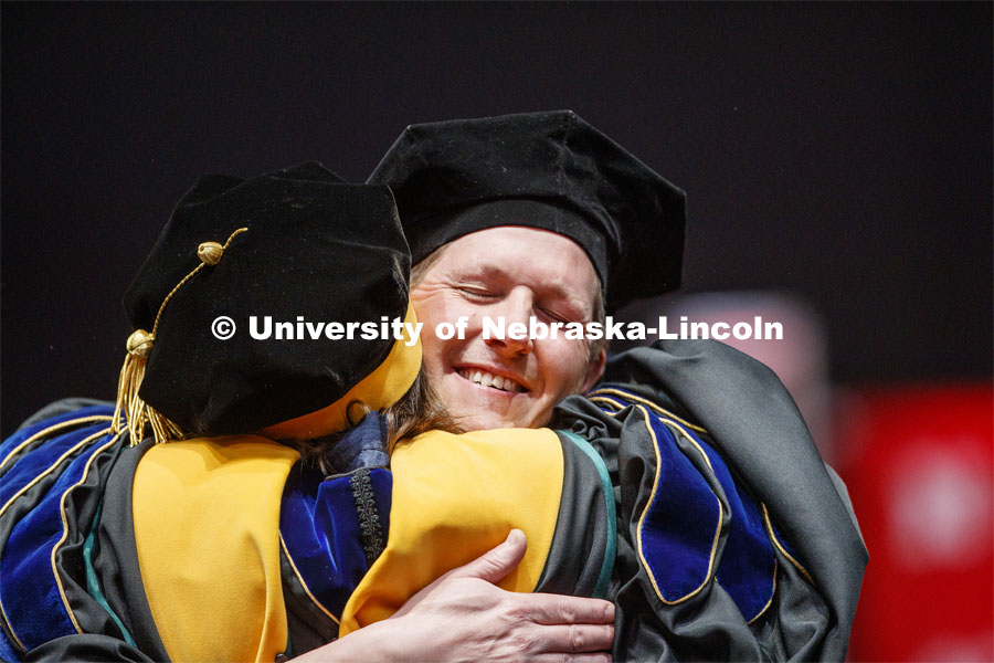 Patrick Janike hugs his advisor Lorraine Males after he received his doctor of education hood. 2019 Spring Graduate Commencement in Pinnacle Bank Arena. May 3, 2019. Photo by Craig Chandler / University Communication