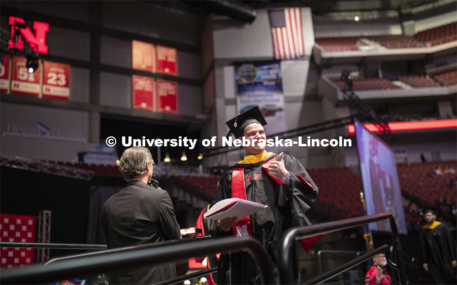 Tyler Moravec gives his family and friends a thumbs up after receiving his Master of Science in Construction Engineering and Management. 2019 Spring Graduate Commencement in Pinnacle Bank Arena. May 3, 2019. Photo by Craig Chandler / University Communication