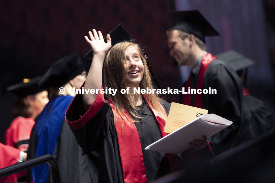 Lindsey Amen waves after receiving her college of journalism diploma. Undergraduate commencement at Pinnacle Bank Arena, May 4, 2019. Photo by Craig Chandler / University Communication.