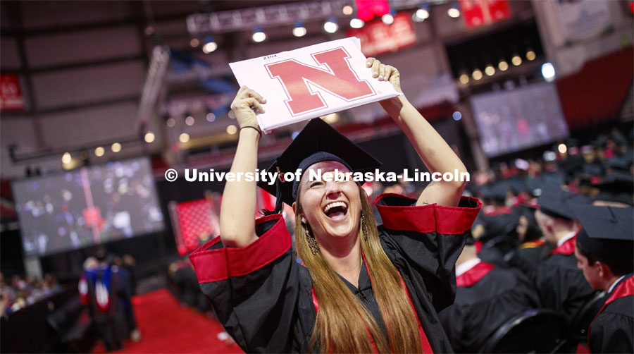 Hailey Lehms celebrates her CoJMC degree as she returns to her seat. Undergraduate commencement at Pinnacle Bank Arena, May 4, 2019. Photo by Craig Chandler / University Communication.