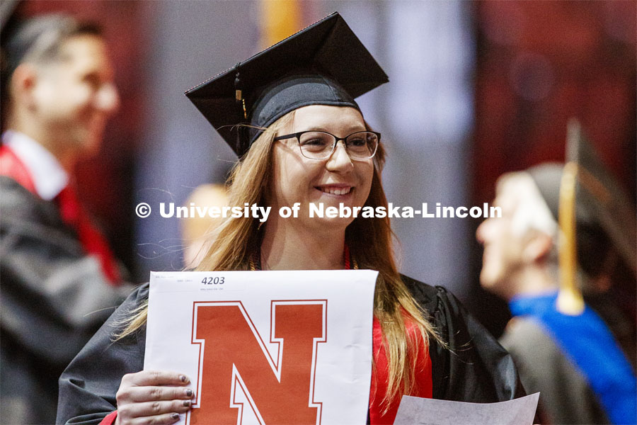 Abby Kile smiles at family and friends after receiving her College of Business diploma. Undergraduate commencement at Pinnacle Bank Arena, May 4, 2019. Photo by Craig Chandler / University Communication.