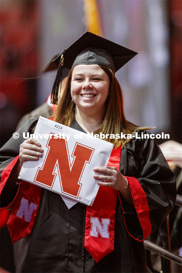 Morgan Krause smiles at family and friends after receiving her College of Business diploma. Undergraduate commencement at Pinnacle Bank Arena, May 4, 2019. Photo by Craig Chandler / University Communication.