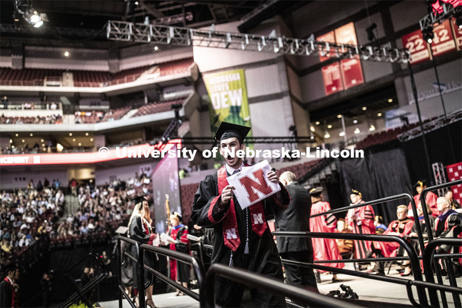 Benjamin Vaske gestures to family and friends after receiving his College of Business diploma. Undergraduate commencement at Pinnacle Bank Arena, May 4, 2019. Photo by Craig Chandler / University Communication.