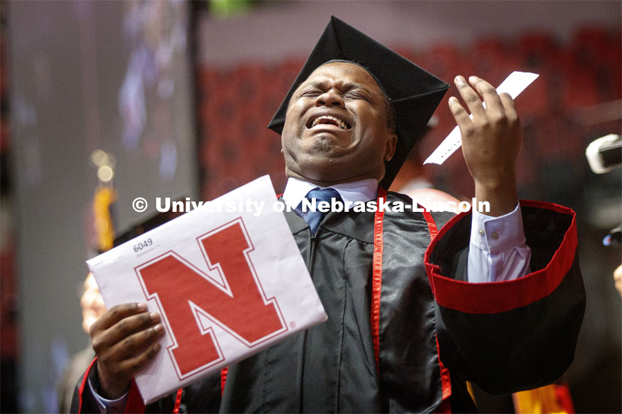 Treymayne Perryman gestures to family and friends as he walks off stage with his Fine and Performing Arts degree. Undergraduate commencement at Pinnacle Bank Arena, May 4, 2019. Photo by Craig Chandler / University Communication.