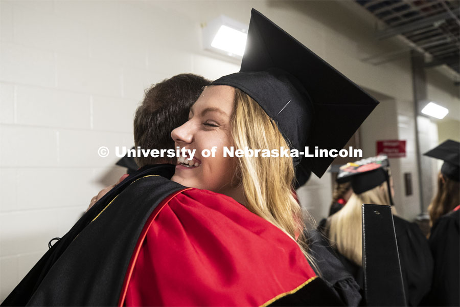 Chancellor Ronnie Green takes a moment to hug his youngest daughter, Regan, before the afternoon ceremony. Regan is the youngest of the Green's five children and the family holds 10 UNL degrees between them. Undergraduate commencement at Pinnacle Bank Arena, May 4, 2019. Photo by Craig Chandler / University Communication.