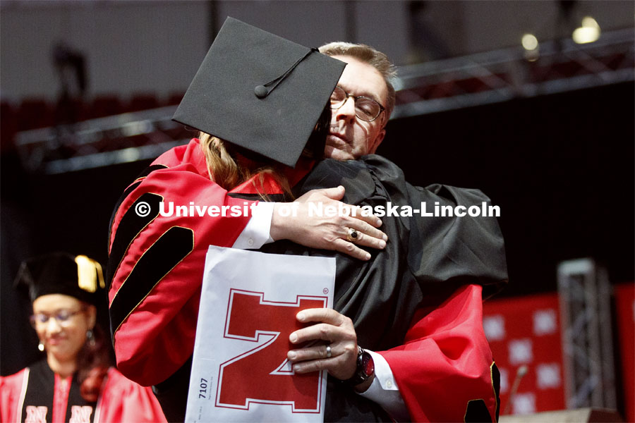 Chancellor Ronnie Green takes a moment to hug his youngest daughter, Regan, after he presented her with her diploma. Regan is the youngest of the Green's five children and the family holds 10 UNL degrees between them. Undergraduate commencement at Pinnacle Bank Arena, May 4, 2019. Photo by Craig Chandler / University Communication.