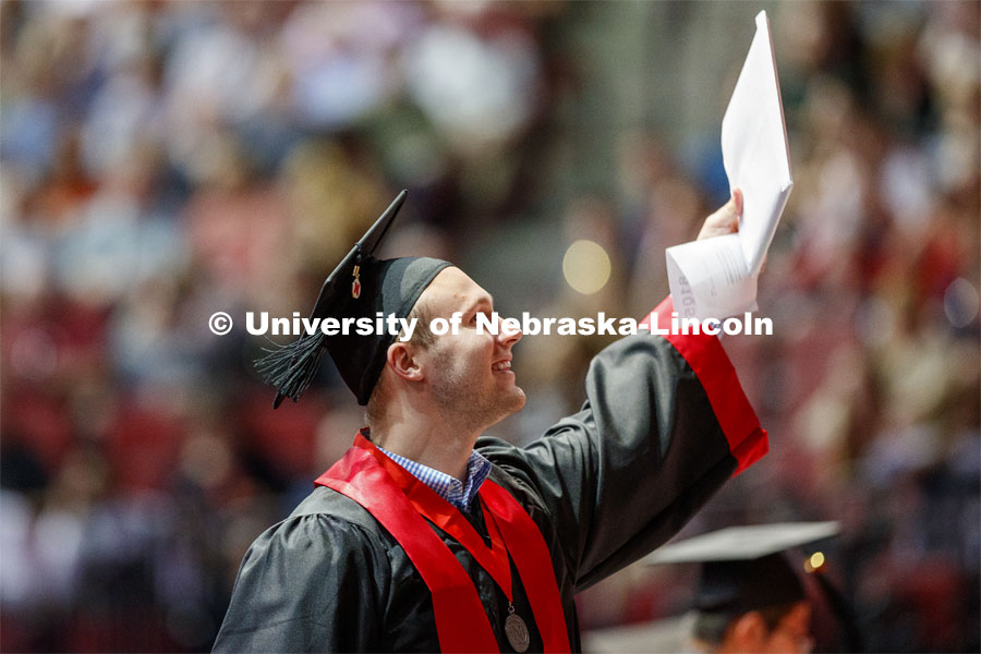 Graduate shows off his Engineering degree to family and friends Saturday afternoon. Undergraduate commencement at Pinnacle Bank Arena, May 4, 2019.  Photo by Craig Chandler / University Communication.