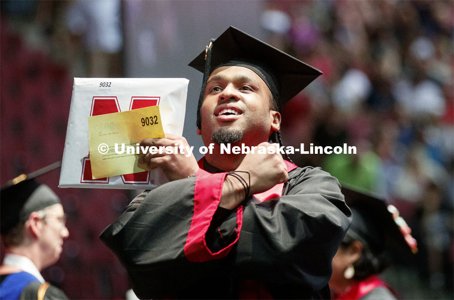 Journey Avila throws the bones to family and friends. Undergraduate commencement at Pinnacle Bank Arena, May 4, 2019. Photo by Craig Chandler / University Communication.