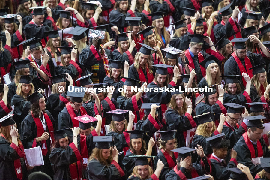 Graduates move their tassels from right to left at the end of the ceremony to signify they are now graduates of the University of Nebraska-Lincoln. Undergraduate commencement at Pinnacle Bank Arena, May 4, 2019. Photo by Craig Chandler / University Communication.