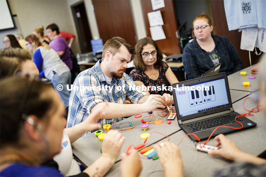 Carl Spicher and Rossella Tesch from the Chadron Public Library work on programming and circuitry that allows small current going through their fingers to play notes on a Play-Doh keyboard, as part of the Library Innovation Studios. Training was held in the Atrium building in downtown Lincoln, Nebraska. May 22, 2019. Photo by Craig Chandler / University Communication.