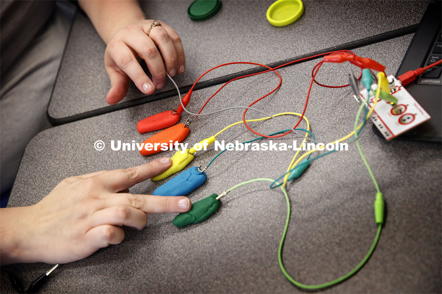 The trainers learn programing and circuitry that allows a small current going through their fingers to play notes on a Play-Doh keyboard, as part of the Library Innovation Studios. Training was held in the Atrium building in downtown Lincoln, Nebraska. May 22, 2019. Photo by Craig Chandler / University Communication.