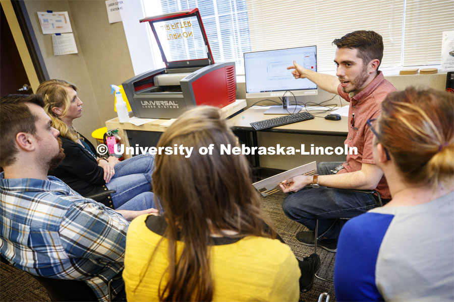 Max Wheeler (pointing to computer screen), NIS instructional designer, leads a training for Library Innovation Studios. Training was held in the Atrium building in downtown Lincoln, Nebraska. May 22, 2019. Photo by Craig Chandler / University Communication.