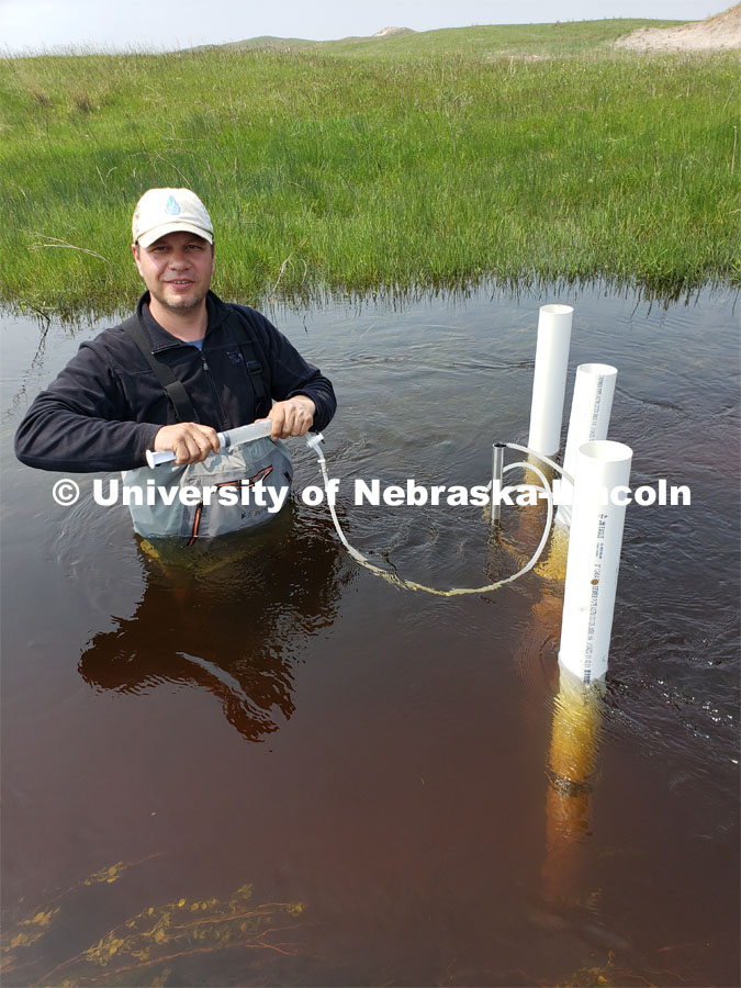 Researchers with the University of Nebraska-Lincoln take groundwater samples from the Loup River in the Sandhills of Nebraska . By sampling groundwater and determining its age, they hope to determine whether predictions for groundwater discharge rates and contamination removal in watersheds are accurate. 190514 Troy Gilmore