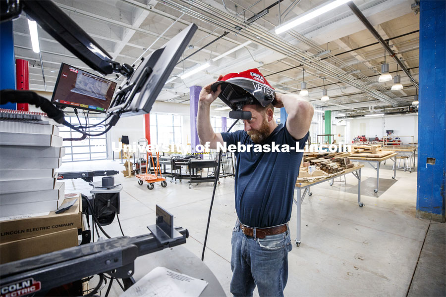 Studio manager Jerry Reif dons a virtual reality welding helmet to demonstrate the new welding trainers. The virtual welders will be available to train aspiring welders. Nebraska Innovation Studio. June 14, 2019.  Photo by Craig Chandler / University Communication
