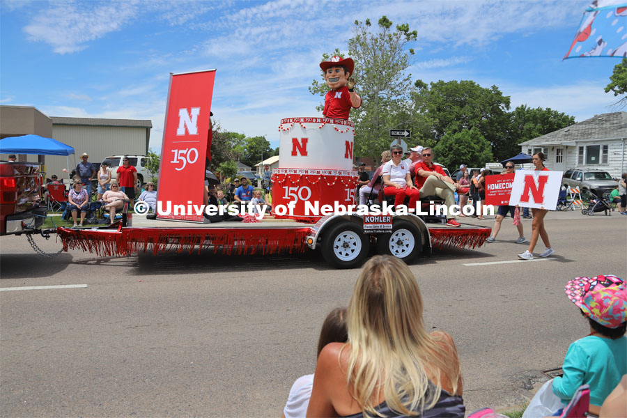 Chancellor Ronnie Green, Jane Green and University Board of Regents member Bob Phares and his wife, Margene Phares, along with Herbie Husker on the UNL Nebraskaland Days parade float in North Platte, NE.  4-H'ers handed out candy along the parade route. The traveling exhibit was displayed at the rodeo grounds. June 15, 2019. Photos by Developing Memories for University Communication.