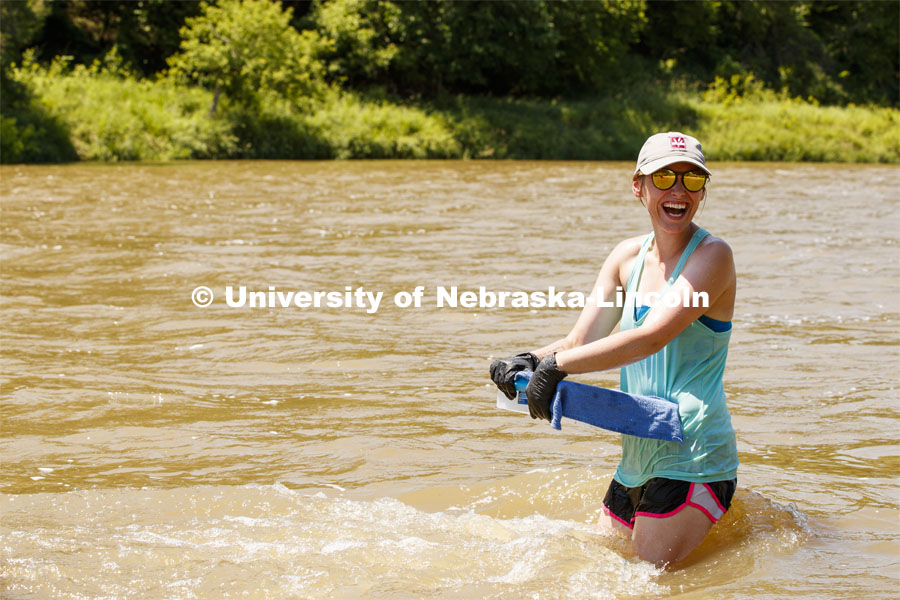 Kayla Vondracek, junior in Environmental Studies, laughs with her professor while collecting samples in the Niobrara River. Jessica Corman, assistant professor in the School of Natural Resources, UCARE research group researching algae in the Niobrara River. Fort Niobrara National Wildlife Refuge. July 12, 2019. Photo by Craig Chandler / University Communication.