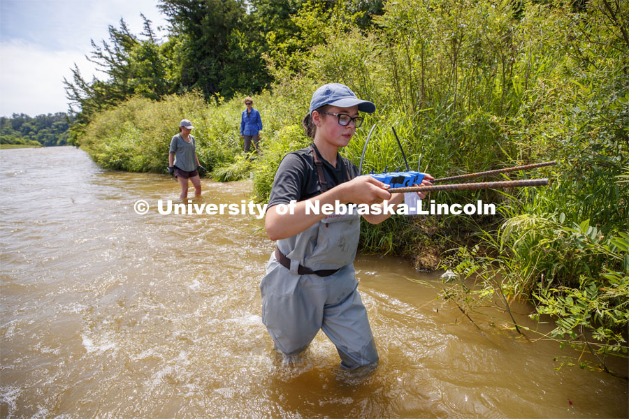 Sydney Kimnach, sophomore in environmental studies and fisheries and wildlife management, carries her research project to the bank of the Niobrara. She places a collection of filter plates each saturated with elements, such as potassium, to see if the algae are attracted to various nutrients. Her multiple sites also allow her to research if algae in different areas of the river seek out different nutrients. Jessica Corman, assistant professor in the School of Natural Resources, UCARE research group researching algae in the Niobrara River. Fort Niobrara National Wildlife Refuge. July 13, 2019. Photo by Craig Chandler / University Communication.