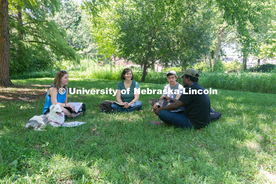 Elizabeth VanWormer, Nebraska One Health coordinator and assistant professor in the School of Veterinary Medicine and Biomedical Sciences and the School of Natural Resources at the University of Nebraska– Lincoln. Photo for the 2019 publication of the Strategic Discussions for Nebraska magazine. Elizabeth is pictured sitting outside with a group of grad students. July 29, 2019. Photo by Gregory Nathan / University Communication.