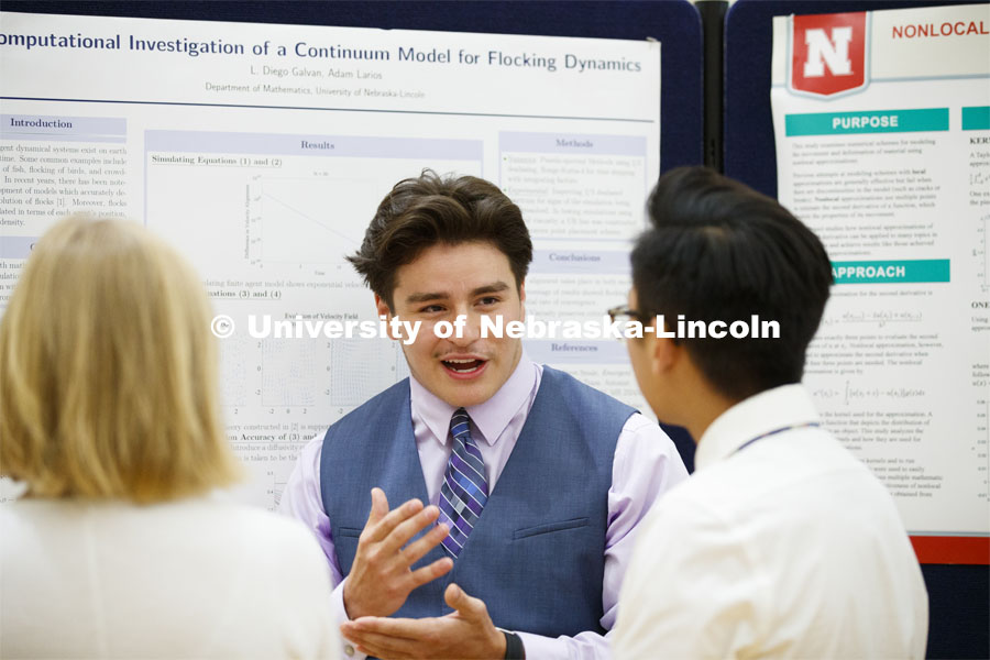 L. Diego Galvan discusses his summer research on the computational investigation of a continuum model for flocking dynamics. Summer Research poster session in the Nebraska Union. August 7, 2019. Photo by Craig Chandler / University Communication.