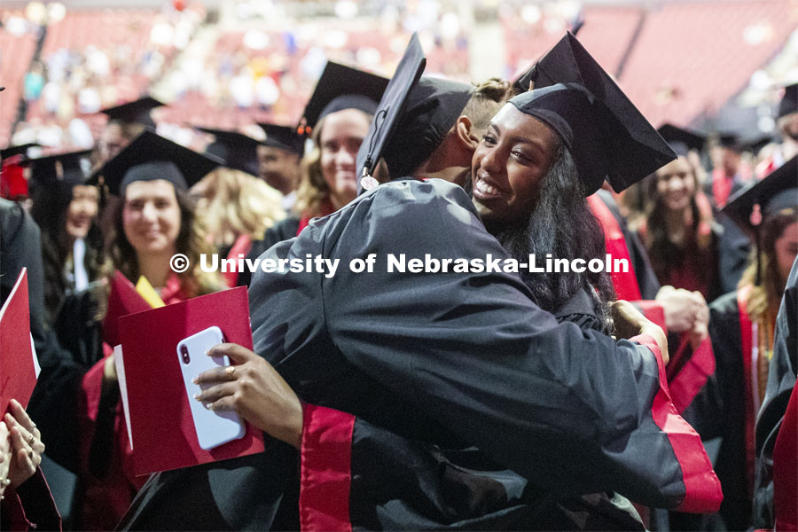 Jace Anderson and Bezawit Bekele hug during the ceremony when Regent Tim Claire asked all the grads to interact with the people around them. 2019 Summer Commencement at Pinnacle Bank Arena. August 17, 2019. Photo by Craig Chandler / University Communication.