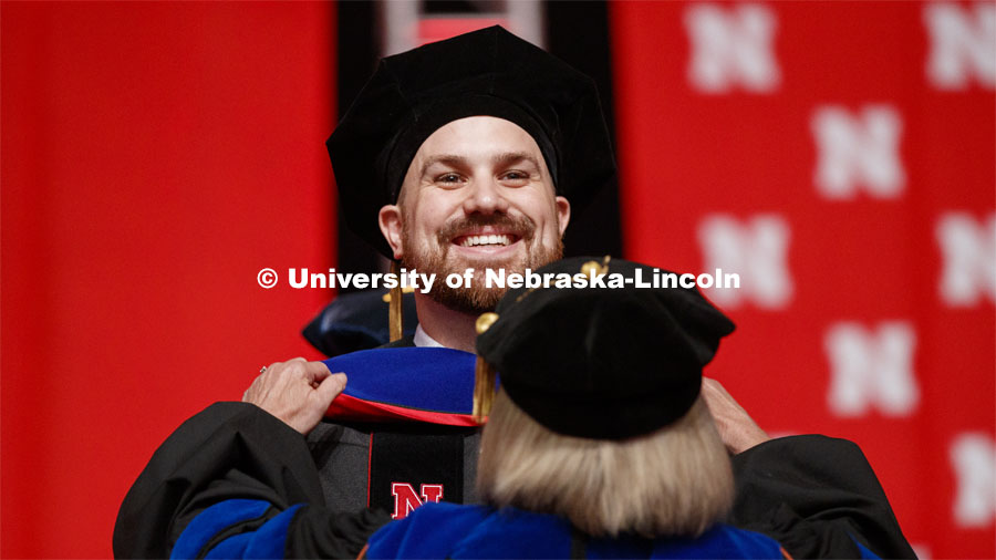 Zachary Myers is hooded by his advisor Sue Swearer. 2019 Summer Commencement at Pinnacle Bank Arena. August 17, 2019. Photo by Craig Chandler / University Communication.