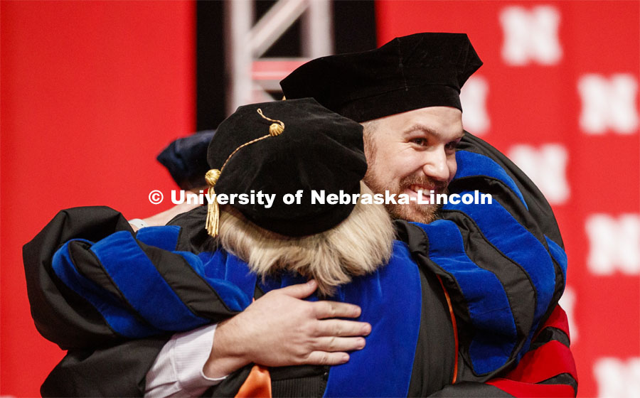 Zachary Myers hugs his advisor Sue Swearer after he received his doctoral hood. 2019 Summer Commencement at Pinnacle Bank Arena. August 17, 2019. Photo by Craig Chandler / University Communication.