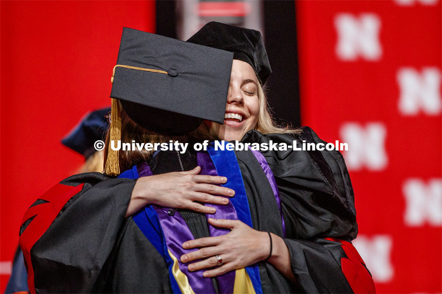 Amy Mantz hugs her advisor Angie Pannier as she receives her doctoral hood. 2019 Summer Commencement at Pinnacle Bank Arena. August 17, 2019. Photo by Craig Chandler / University Communication.