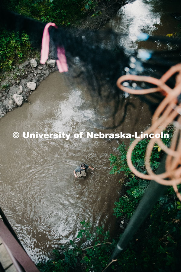 Nebraska graduate student Christopher Fill is studying the patterns of bats living at Homestead National Monument near Beatrice. Ben Hale out in the creek getting ready to drop nets. August 19, 2019. Photo by Justin Mohling / University Communication.