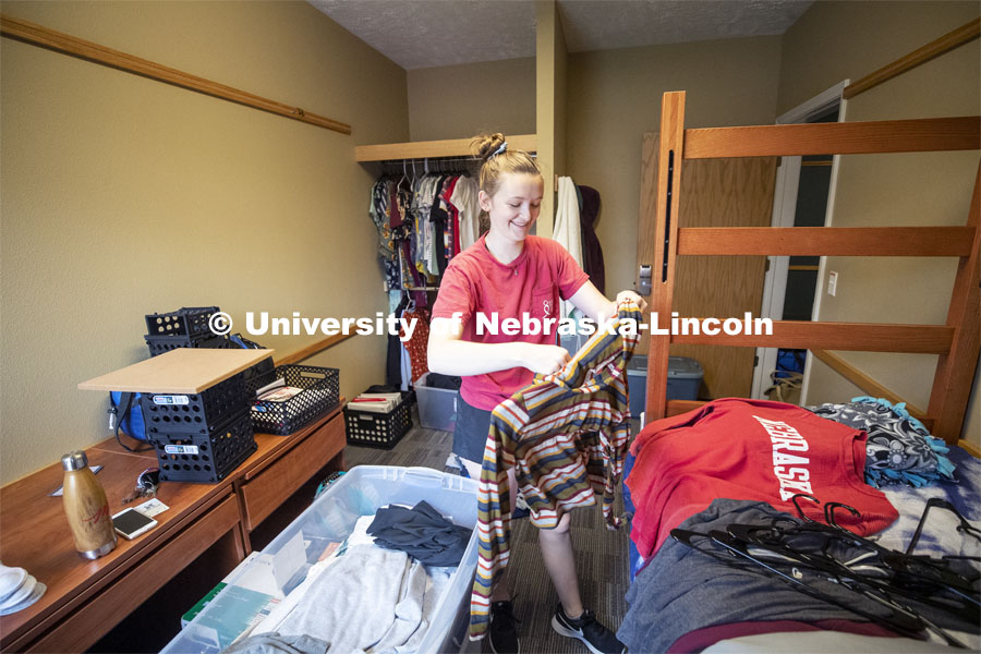 Lori White, a freshman from Mitchell, South Dakota, starts unpacking her belongings into her Knoll Residence Residential Center room. Lori is a freshman in the Honors program. Residential hall move-in to the Knoll Residential Center and University Suites. August 22, 2019. Photo by Craig Chandler / University Communication.