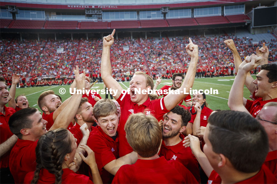 Sam Brown, an alto saxophone player from Omaha, celebrates with fellow band members after winning the annual drill down marching competition. Cornhusker Marching Band Exhibition Performance. August 23, 2019. Photo by Craig Chandler / University Communication.