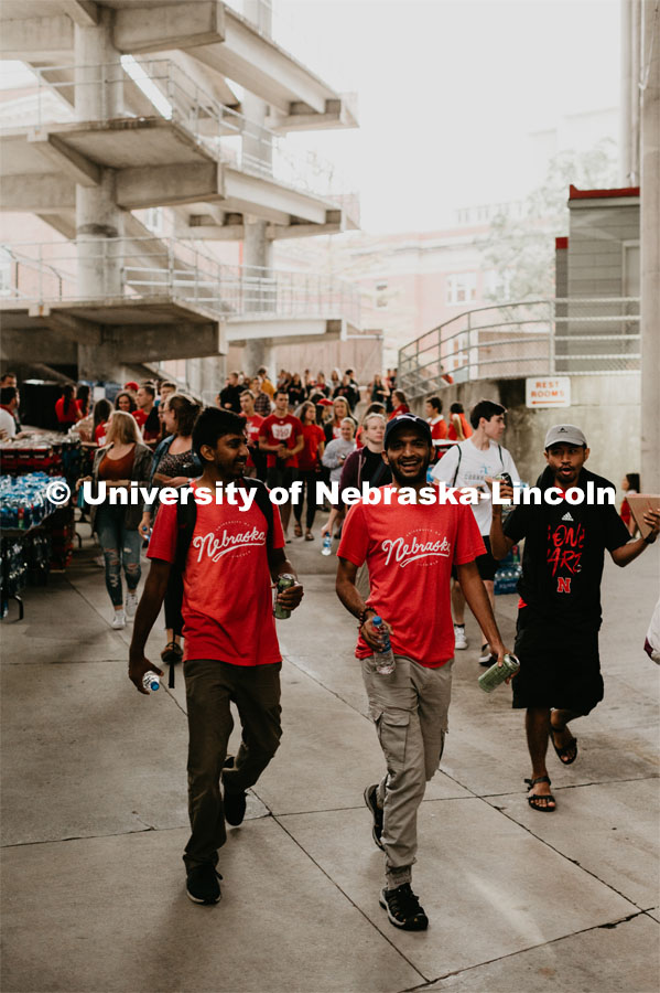 International students about to experience their first football game. Students got to check out the 2019 Husker Football Team at the Big Red Welcome Boneyard Bash. The first 2500 students got a free slice of Valentino’s pizza, water, and a 2019 Official Boneyard t-shirt. August 24, 2019. Photo by Justin Mohling / University Communication.