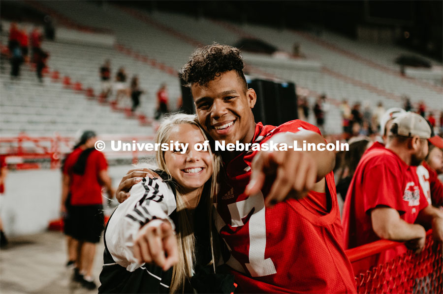 Football players meeting fans and students. Student making a catch and the team going wild, she was the only one to catch the ball. Students got to check out the 2019 Husker Football Team at the Big Red Welcome Boneyard Bash. The first 2500 students got a free slice of Valentino’s pizza, water, and a 2019 Official Boneyard t-shirt. August 24, 2019. Photo by Justin Mohling / University Communication.