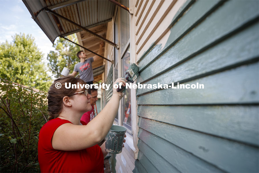 First year law students, faculty and staff paint two Lincoln houses. The painting is a yearly tradition for the incoming students. August 24, 2019. Photo by Craig Chandler / University Communication.