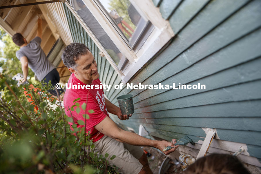 Richard Moberly, Interim Executive Vice Chancellor and Chief Academic Officer paints alongside incoming law students at a home at 30th and Vine. First year law students, faculty and staff paint two Lincoln houses. The painting is a yearly tradition for the incoming students. August 24, 2019. Photo by Craig Chandler / University Communication.