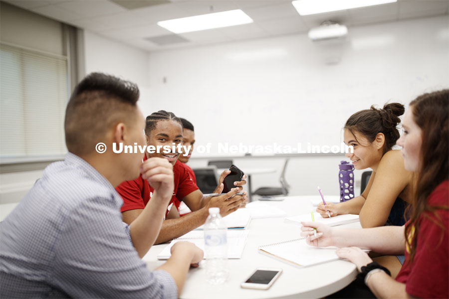 Justin Nguyen (left) talks with freshmen Matthew Brown (second from left) and Cleopatra Babor (second from right) during a Calculus 106 recitation in Louise Pound Hall. August 29, 2019. Photo by Craig Chandler / University Communication.
