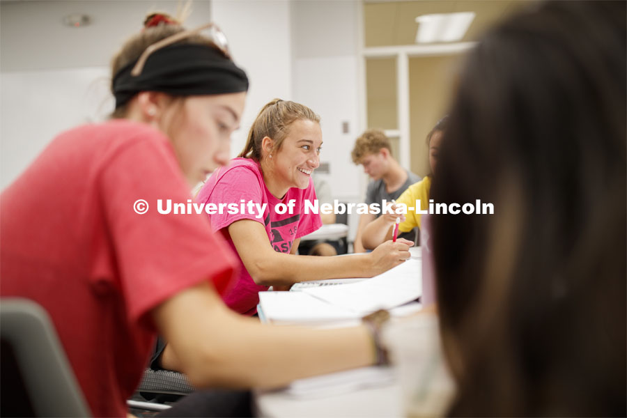 Izzy Lesiak, freshman from Lincoln, smiles at a friend as they work on problems. Calculus 106 recitation in Louise Pound Hall taught by Justin Nguyen. August 29, 2019. Photo by Craig Chandler / University Communication.
