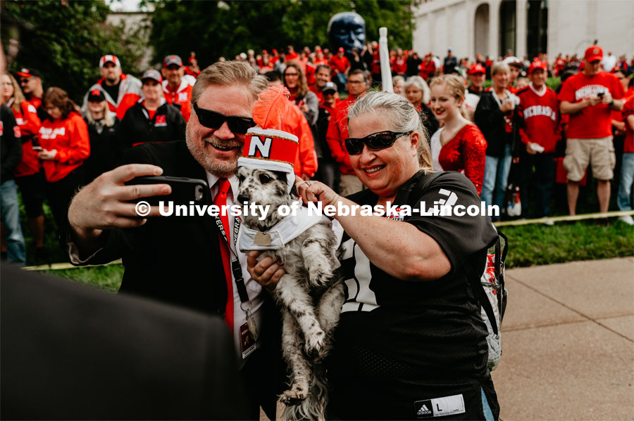 Doug Bush, lecturer at the Glenn Korff School of Music,  poses for a selfie with Joey the Cornhusker Marching Band dog. Nebraska vs. Southern Alabama football game. August 31, 2019. Photo by Justin Mohling / University Communication.
