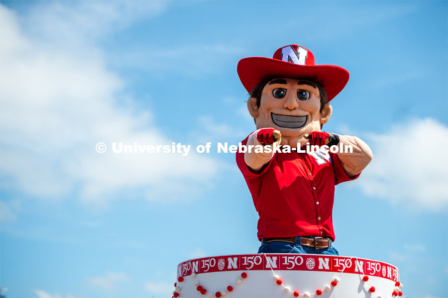 Herbie pointing out of his cake. The University of Nebraska represents and celebrates their 150th year anniversary at the Nebraska State Fair in Grand Island, Nebraska. August 1, 2019. Photo by Justin Mohling for University Communication.