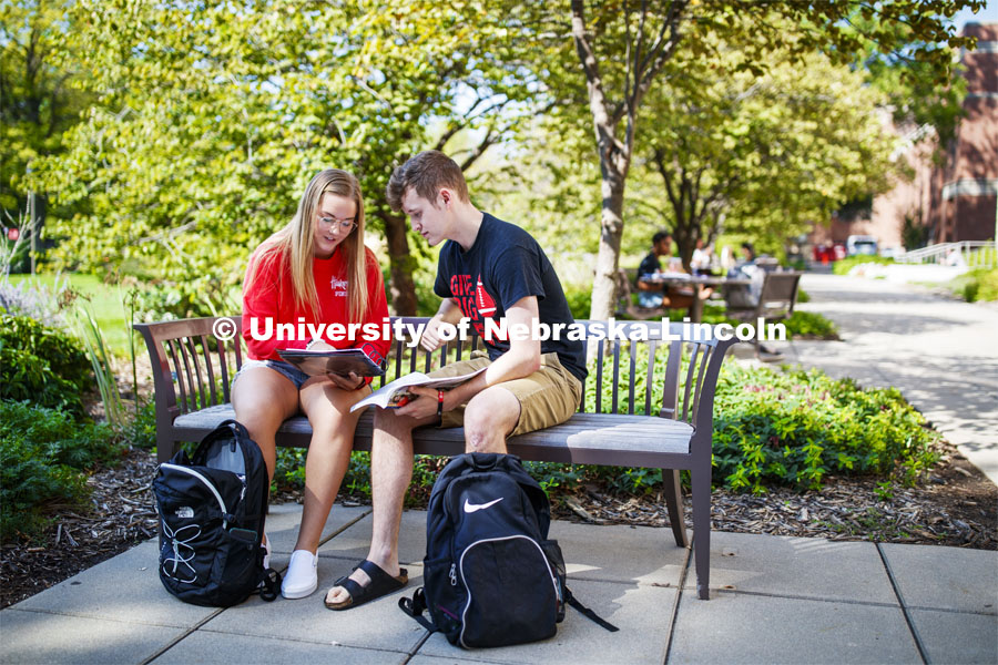 Students sitting at a bench studying. Explore Center photo shoot. September 10, 2019. Photo by Craig Chandler / University Communication.