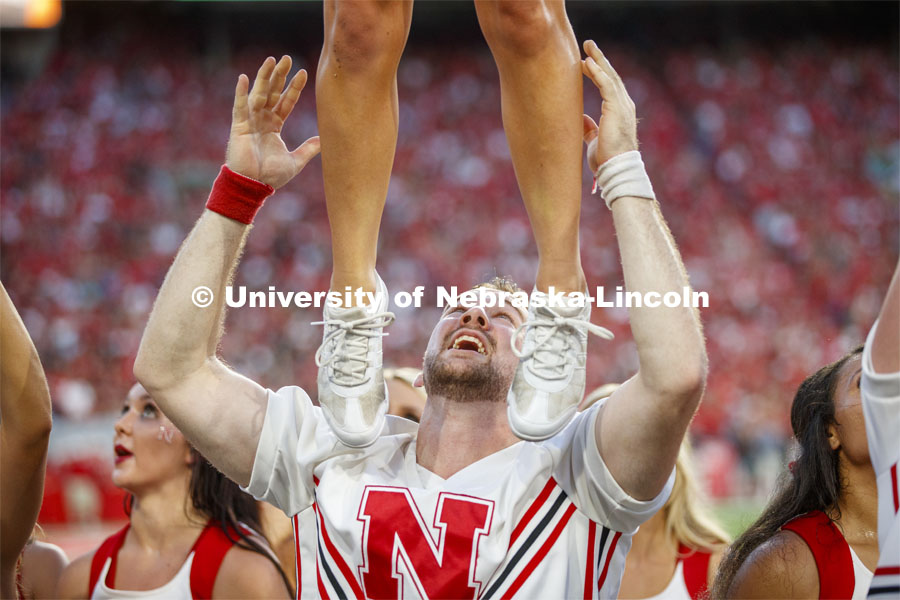 Jake Jundt one of the male cheerleaders assists with a lift at the Nebraska vs. Northern Illinois football game. September 14, 2019. Photo by Craig Chandler / University Communication.